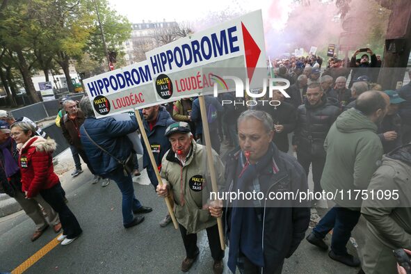 Protesters from Brittany hold a placard that reads ''Hippodrome Loudeac'' as they participate in a demonstration organized by horse racing a...