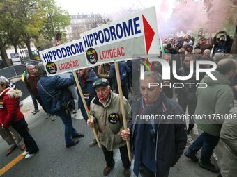 Protesters from Brittany hold a placard that reads ''Hippodrome Loudeac'' as they participate in a demonstration organized by horse racing a...