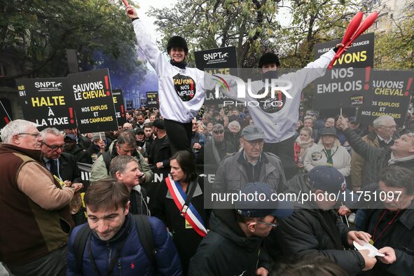 Protesters hold a placard that reads ''Stop taxing!'', ''No to taxation of horse-race betting!'' and ''Let's save the horse! our jobs and ou...