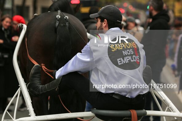 A jockey with her horse, wearing white jockey silks reading ''Keep jobs,'' takes part in a demonstration organized by horse racing associati...