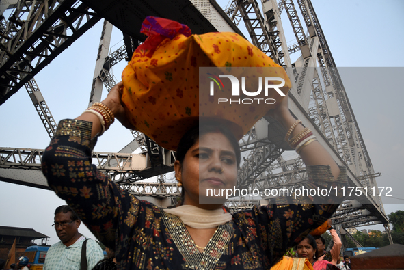 Hindu women devotees arrive at Ganga Ghat during the Hindu festival Chhath in Kolkata, India, on November 7, 2024. The 'Chhath' festival is...