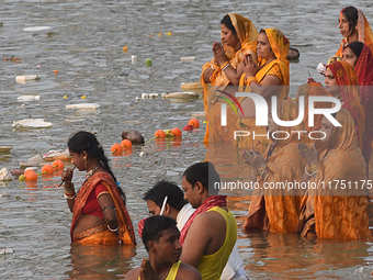 Hindu women devotees perform rituals in a water body in the river Ganga during the Hindu festival Chhath in Kolkata, India, on November 7, 2...