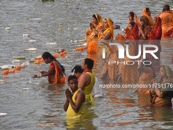 Hindu women devotees perform rituals in a water body in the river Ganga during the Hindu festival Chhath in Kolkata, India, on November 7, 2...