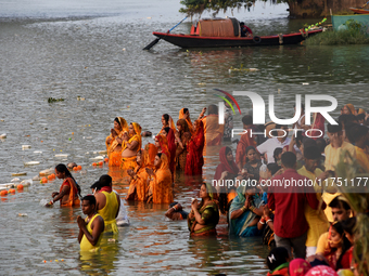 Hindu women devotees perform rituals in a water body in the river Ganga during the Hindu festival Chhath in Kolkata, India, on November 7, 2...