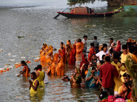 Hindu women devotees perform rituals in a water body in the river Ganga during the Hindu festival Chhath in Kolkata, India, on November 7, 2...