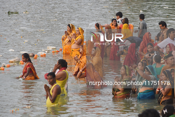 Hindu women devotees perform rituals in a water body in the river Ganga during the Hindu festival Chhath in Kolkata, India, on November 7, 2...