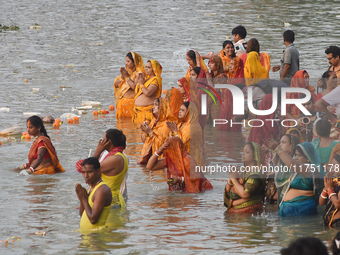 Hindu women devotees perform rituals in a water body in the river Ganga during the Hindu festival Chhath in Kolkata, India, on November 7, 2...