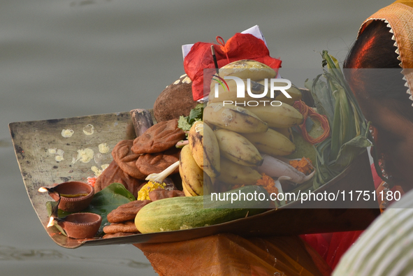 Hindu women devotees perform rituals in the river Ganga in front of the iconic Howrah Bridge during the Hindu festival Chhath in Kolkata, In...