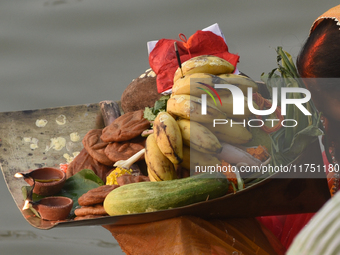 Hindu women devotees perform rituals in the river Ganga in front of the iconic Howrah Bridge during the Hindu festival Chhath in Kolkata, In...