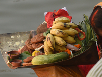 Hindu women devotees perform rituals in the river Ganga in front of the iconic Howrah Bridge during the Hindu festival Chhath in Kolkata, In...