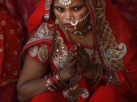 A Hindu woman devotee takes a rest after performing rituals in the river Ganga during the Hindu festival Chhath in Kolkata, India, on Novemb...