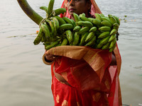 Hindu women devotees perform rituals in a water body of the river Ganga in front of the iconic Howrah Bridge during the Hindu festival Chhat...