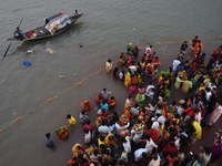 Hindu women devotees perform rituals in the river Ganga in front of the iconic Howrah Bridge during the Hindu festival Chhath in Kolkata, In...