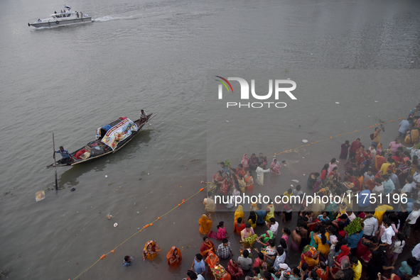 Hindu women devotees perform rituals in the river Ganga in front of the iconic Howrah Bridge during the Hindu festival Chhath in Kolkata, In...