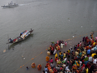 Hindu women devotees perform rituals in the river Ganga in front of the iconic Howrah Bridge during the Hindu festival Chhath in Kolkata, In...