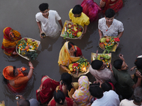 Hindu women devotees perform rituals in the river Ganga in front of the iconic Howrah Bridge during the Hindu festival Chhath in Kolkata, In...