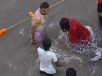 Hindu women devotees perform rituals in the river Ganga in front of the iconic Howrah Bridge during the Hindu festival Chhath in Kolkata, In...