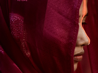 An Indian Hindu woman performs religious rituals near the Arabian Sea on the day of the Chhath Puja festival in Mumbai, India, on November 7...