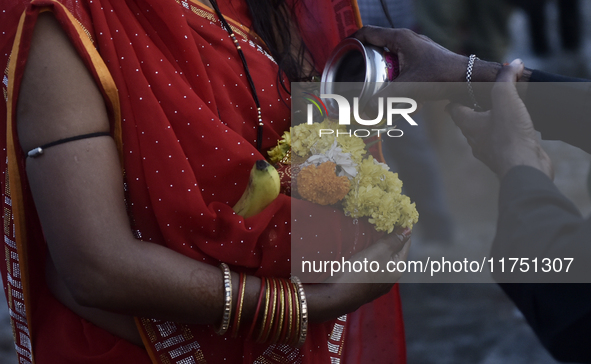 Hindu devotees perform religious rituals near the Arabian Sea on the day of the Chhath Puja festival in Mumbai, India, on November 7, 2024....