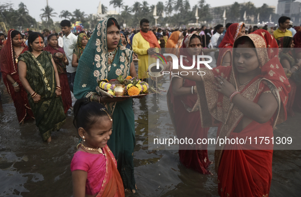 Hindu devotees perform religious rituals near the Arabian Sea on the day of the Chhath Puja festival in Mumbai, India, on November 7, 2024....