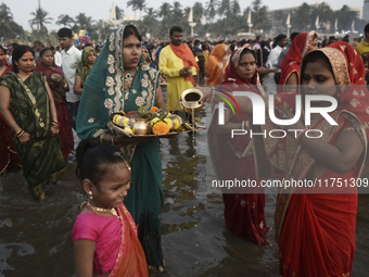 Hindu devotees perform religious rituals near the Arabian Sea on the day of the Chhath Puja festival in Mumbai, India, on November 7, 2024....