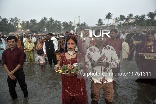 Hindu devotees perform religious rituals near the Arabian Sea on the day of the Chhath Puja festival in Mumbai, India, on November 7, 2024....