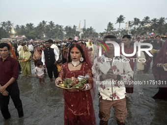 Hindu devotees perform religious rituals near the Arabian Sea on the day of the Chhath Puja festival in Mumbai, India, on November 7, 2024....