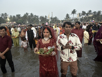 Hindu devotees perform religious rituals near the Arabian Sea on the day of the Chhath Puja festival in Mumbai, India, on November 7, 2024....