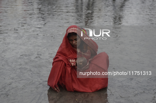 A Hindu devotee performs religious rituals near the Arabian Sea on the day of the Chhath Puja festival in Mumbai, India, on November 7, 2024...