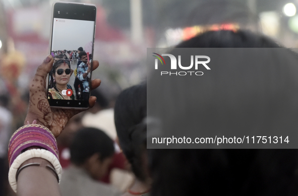 A Hindu devotee takes a selfie with her mobile phone near the Arabian Sea during the Chhath Puja festival in Mumbai, India, on November 7, 2...