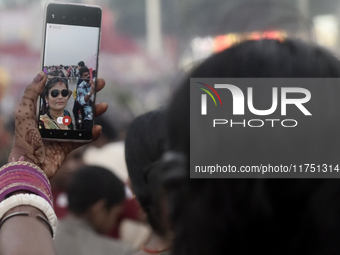 A Hindu devotee takes a selfie with her mobile phone near the Arabian Sea during the Chhath Puja festival in Mumbai, India, on November 7, 2...