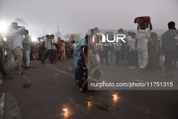 A Hindu devotee lights diyas on a beach near the Arabian Sea during the Chhath Puja festival in Mumbai, India, on November 7, 2024. The Chha...