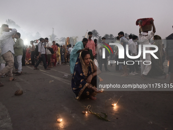 A Hindu devotee lights diyas on a beach near the Arabian Sea during the Chhath Puja festival in Mumbai, India, on November 7, 2024. The Chha...