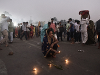 A Hindu devotee lights diyas on a beach near the Arabian Sea during the Chhath Puja festival in Mumbai, India, on November 7, 2024. The Chha...