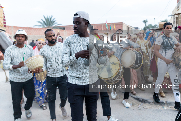 Bedouin wedding orchestra march on the street as wedding guests escort the bride to her husband's home in Tozeur, north west of Sahara, Tuni...