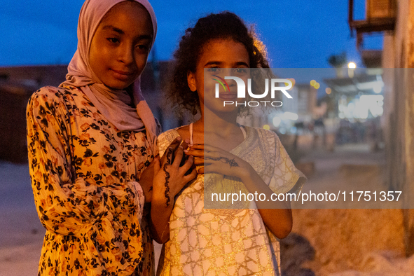 Bedouin girls pose to be photographed during wedding in Tozeur, north west of Sahara, Tunisia on October 28, 2024 