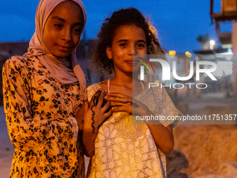 Bedouin girls pose to be photographed during wedding in Tozeur, north west of Sahara, Tunisia on October 28, 2024 (