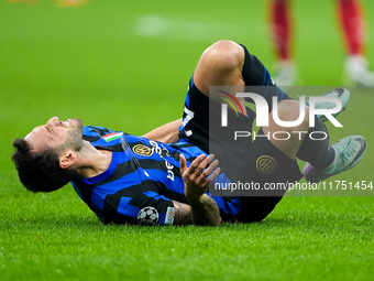 Hakan Calhanoglu of FC Internazionale lies down injured during the UEFA Champions League 2024/25 League Phase MD4 match between FC Internazi...