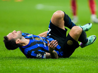 Hakan Calhanoglu of FC Internazionale lies down injured during the UEFA Champions League 2024/25 League Phase MD4 match between FC Internazi...