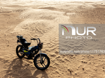 Motorbike is seen on dunes of Eastern Sahara desert on a sunny day on October 30, 2024 near Douz, Tunisia. (