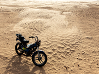 Motorbike is seen on dunes of Eastern Sahara desert on a sunny day on October 30, 2024 near Douz, Tunisia. (