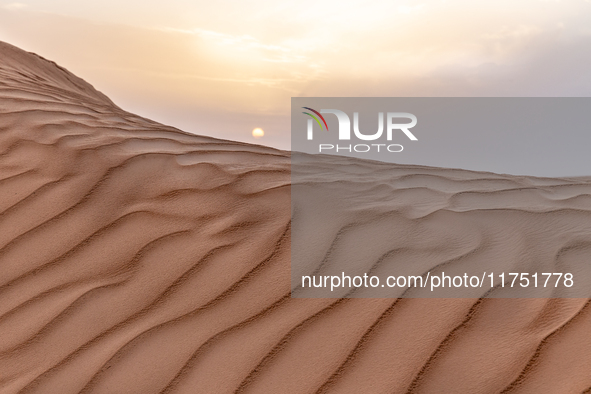 Sunset is seen over dunes of Eastern Sahara desert on on October 30, 2024 near Douz, Tunisia. 