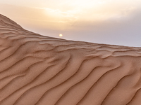 Sunset is seen over dunes of Eastern Sahara desert on on October 30, 2024 near Douz, Tunisia. (