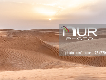 Sunset is seen over dunes of Eastern Sahara desert on on October 30, 2024 near Douz, Tunisia. (