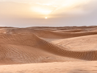 Sunset is seen over dunes of Eastern Sahara desert on on October 30, 2024 near Douz, Tunisia. (