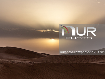 Sunset is seen over dunes of Eastern Sahara desert on on October 30, 2024 near Douz, Tunisia. (