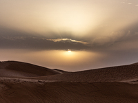 Sunset is seen over dunes of Eastern Sahara desert on on October 30, 2024 near Douz, Tunisia. (