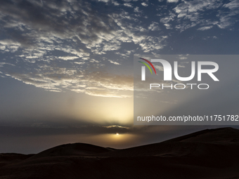 Sunset is seen over dunes of Eastern Sahara desert on on October 30, 2024 near Douz, Tunisia. (