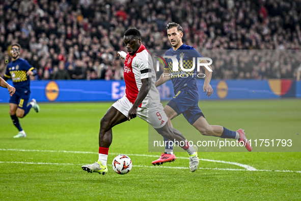 AFC Ajax Amsterdam forward Brian Brobbey and Maccabi Tel Aviv defender Nemanja Stojic play during the match between Ajax and Maccabi Tel Avi...