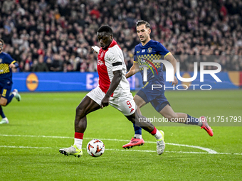 AFC Ajax Amsterdam forward Brian Brobbey and Maccabi Tel Aviv defender Nemanja Stojic play during the match between Ajax and Maccabi Tel Avi...